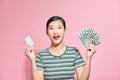 Sweet gorgeous nice adorable good-looking lady hold her money and bank card in hands on pastel pink background make toothy smile Royalty Free Stock Photo