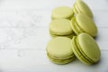 Sweet green macaroons on wooden table