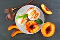 Sweet grilled peaches with vanilla ice cream and caramel sauce, top view table scene on slate Royalty Free Stock Photo