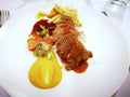 Sweet grilled pork with sweet potato sauce and frence fries serve on a white dish