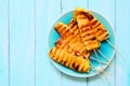 Grilled summer pineapple wedges, overhead view on blue wood