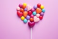 Sweet harmony rainbow heart candies arranged on a pink background