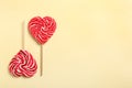 Sweet heart shaped lollipops on beige background, flat lay with space for text. Valentine`s day celebration Royalty Free Stock Photo