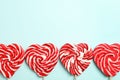 Sweet heart shaped lollipops on light blue background, flat lay with space for text. Valentine`s day celebration Royalty Free Stock Photo