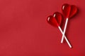 Sweet heart shaped lollipops on red background, flat lay with space for text. Valentine`s day celebration Royalty Free Stock Photo