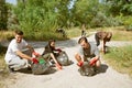 Group of volunteers tidying up rubbish on beach Royalty Free Stock Photo