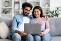 Sweet hindu couple watching movie on laptop at home Royalty Free Stock Photo