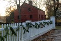 Long white picket fence with tree boughs for decoration, Genesee Country Village & Museum, Rochester, New York, 2017 Royalty Free Stock Photo