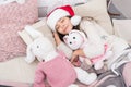 Sweet home. Girl little kid relaxing on bed light interior with christmas decorations. Magical morning. Christmas eve Royalty Free Stock Photo