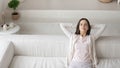 Happy millennial woman resting in living room with modern interior