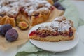 Sweet home made plum crumble pie on a table Royalty Free Stock Photo