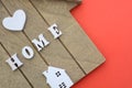 Sweet home sign. House wood with heart shape on wooden background Royalty Free Stock Photo