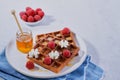 Sweet Homemade Belgian Waffle with Whipped Cream, Raspberry, honey over light backgound, copy space. Selective focus Royalty Free Stock Photo