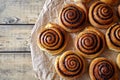 Sweet Homemade christmas baking. Cinnamon rolls buns with cocoa filling on parchment paper. Kanelbulle swedish dessert.