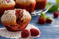 Sweet homemade raspberry muffins on wooden table. Royalty Free Stock Photo