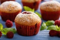 Sweet homemade raspberry muffins on wooden table. Royalty Free Stock Photo