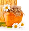 Sweet honey in glass jars with flowers