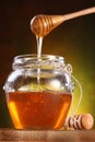 Sweet honey pouring from drizzler into the pot Royalty Free Stock Photo
