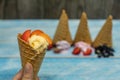 Sweet ice cream in balls in a waffle cone. Different flavors berries and fruits Royalty Free Stock Photo