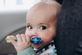 Sweet infant in the car sits in a child seat. Safe driving. Baby care