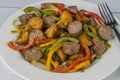 Italian sausage with red roasted potatoes and peppers and onions Royalty Free Stock Photo