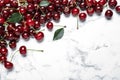 Sweet juicy cherries on white marble table, flat lay. Space for text