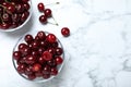 Sweet juicy cherries on white marble table, flat lay. Space for text Royalty Free Stock Photo