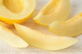 Sweet juicy honeydew melon halfes and slices on a withe wood table. Sweet fruits and berries. Vegetarian, raw food diet and