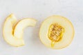 sweet juicy melon on white textured background. flat lay of half a melon and two slices.. The concept of healthy sweets. Royalty Free Stock Photo