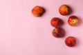 Sweet juicy peaches on pink background, top view.