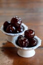 Sweet Jujube or Chinese red date in syrup in white Thai style cup on wood table and space for write wording