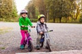 Sweet kids on balance bikes outdoors at the park Royalty Free Stock Photo