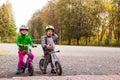 Sweet kids on balance bikes outdoors at the park Royalty Free Stock Photo