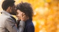 Sweet kiss. African-american man kissing his girlfriend forehead Royalty Free Stock Photo