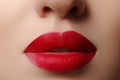 Sweet kiss. Close-up of woman's lips with fashion red make-up. Beautiful female mouth, full lips with perfect makeup