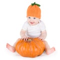 Sweet laughing baby girl with huge pumpkin Royalty Free Stock Photo