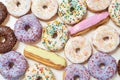 Sweet life. Top view of various colorful tasty and fresh donuts and eclairs, close up shot Royalty Free Stock Photo