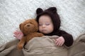 Sweet little baby boy, dressed in handmade knitted brown soft te Royalty Free Stock Photo