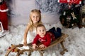 Sweet little baby boy and girl with christmas decorations, playing in the snow Royalty Free Stock Photo