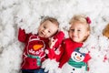 Sweet little baby boy and girl with christmas decorations, playing in the snow Royalty Free Stock Photo