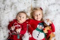 Sweet little baby boy and girl with christmas decorations, playing in the snow Royalty Free Stock Photo