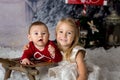 Sweet little baby boy and girl with christmas decorations, playing in the snow Royalty Free Stock Photo
