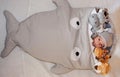 Sweet little baby lying on the bed surrounded of cute safari stuffed animals