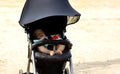 Sweet little baby sleeping in stroller in summer or autumn outdoors Royalty Free Stock Photo