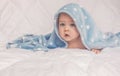 Sweet little blue eyes baby boy portrait with blue blanket on white background Royalty Free Stock Photo