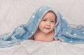 Sweet little blue eyes baby boy portrait with blue blanket on white background Royalty Free Stock Photo