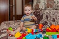 Sweet little boy building tower from cubes at home Royalty Free Stock Photo