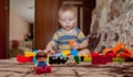 Sweet little boy building tower from cubes at home Royalty Free Stock Photo