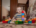 Sweet little boy building tower from cubes at home Royalty Free Stock Photo