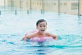 Sweet little boy, swimming in big swimming pool, summertime Royalty Free Stock Photo
